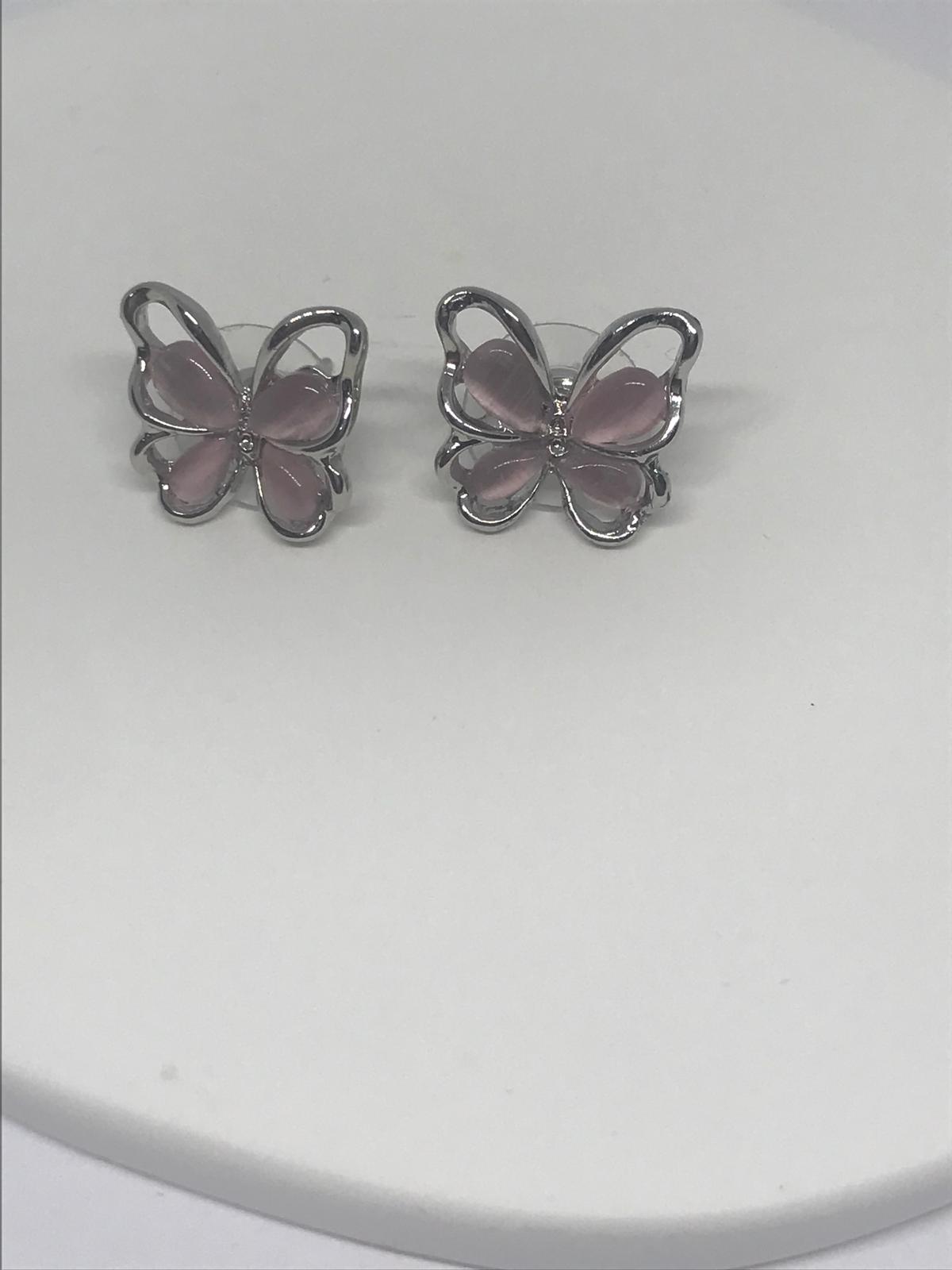 pink butterfly earring showing translucent wings and silver outline"