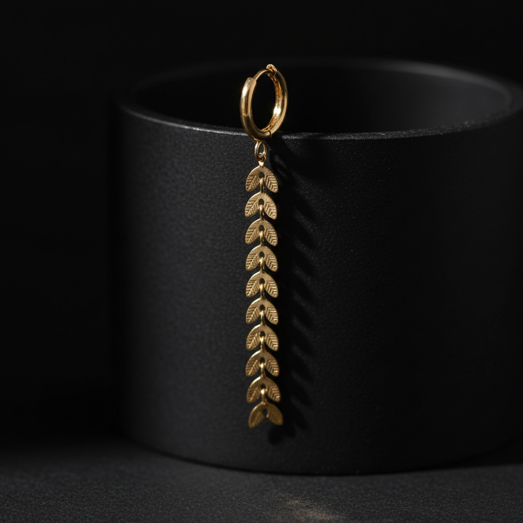 Close-up detail of gold leaf drop earring showing intricate craftsmanship