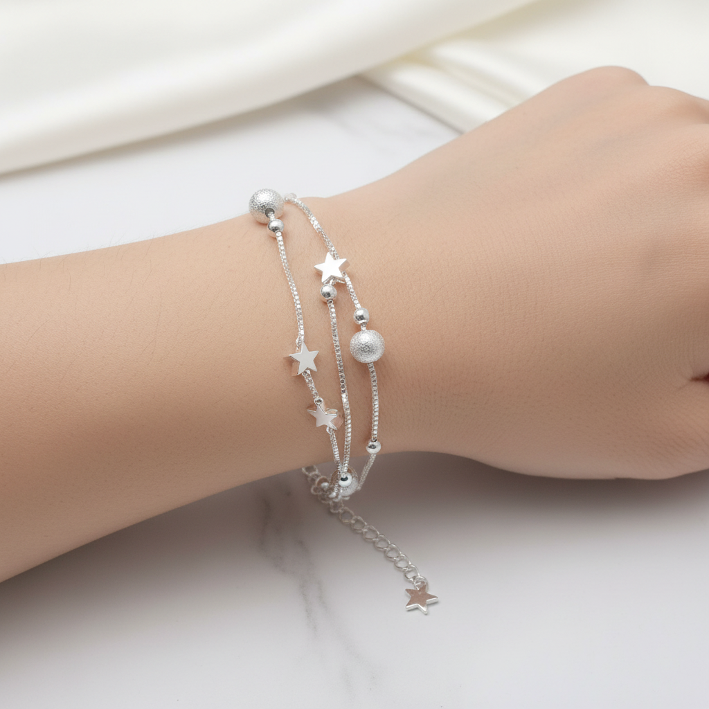 Silver star bracelet layered with other bracelets, boho stacking style