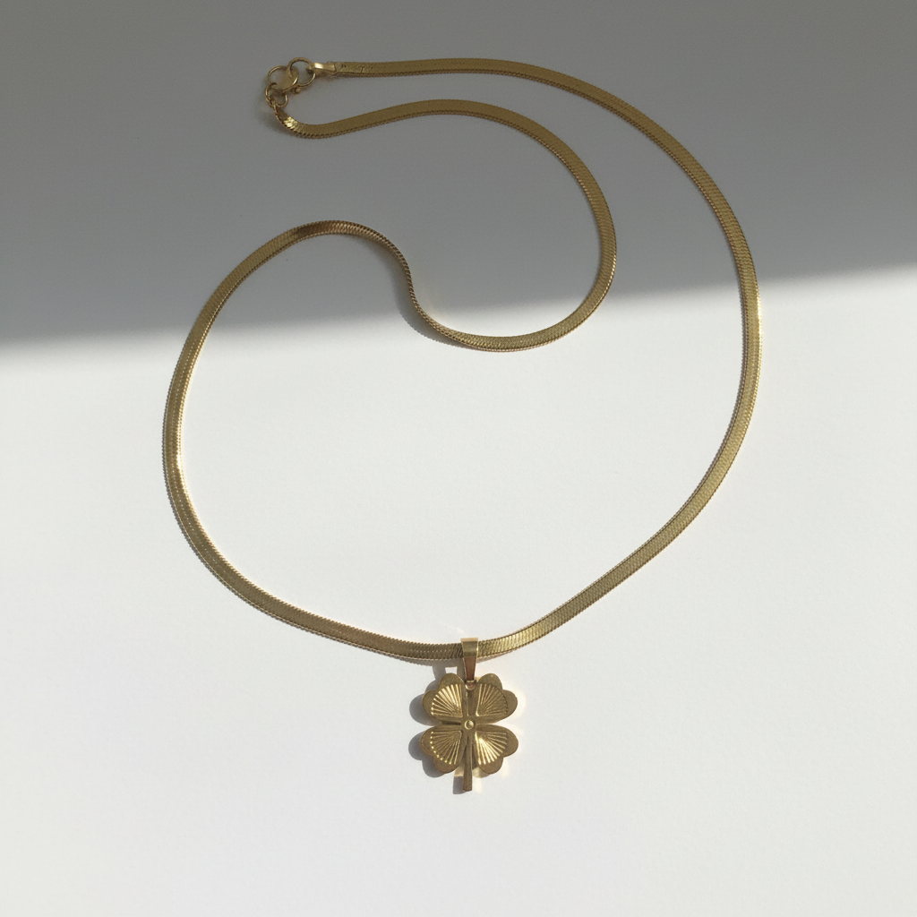 Gold four-leaf clover necklace photographed in natural daylight with authentic shadows"